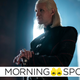 Daemon Targaryen rests his hands upon his sword pommel with a slight smile upon his face.